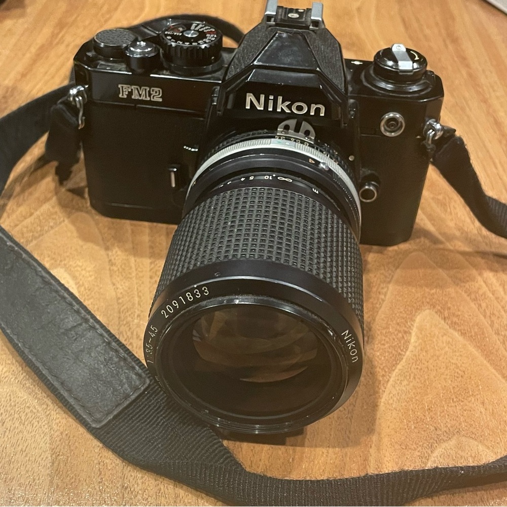 Vintage Nikon FM2 black camera with lens